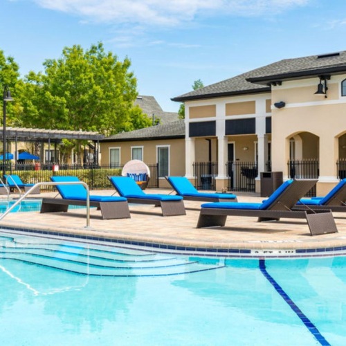 Resort-style swimming pool a swimming pool with lounge chairs