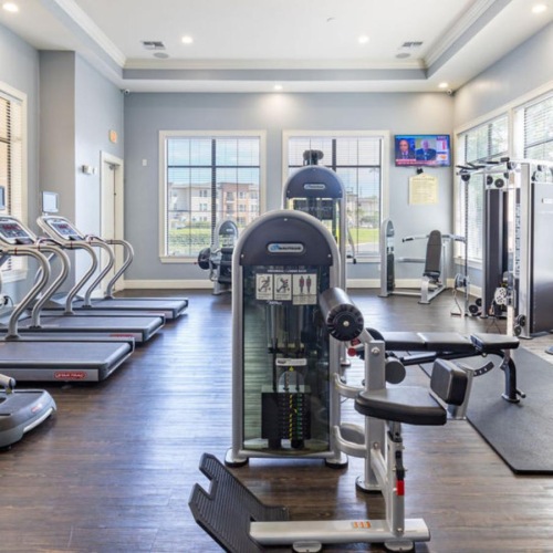 Quick access to state-of-the-art amenities large gym with recessed lighting throughout