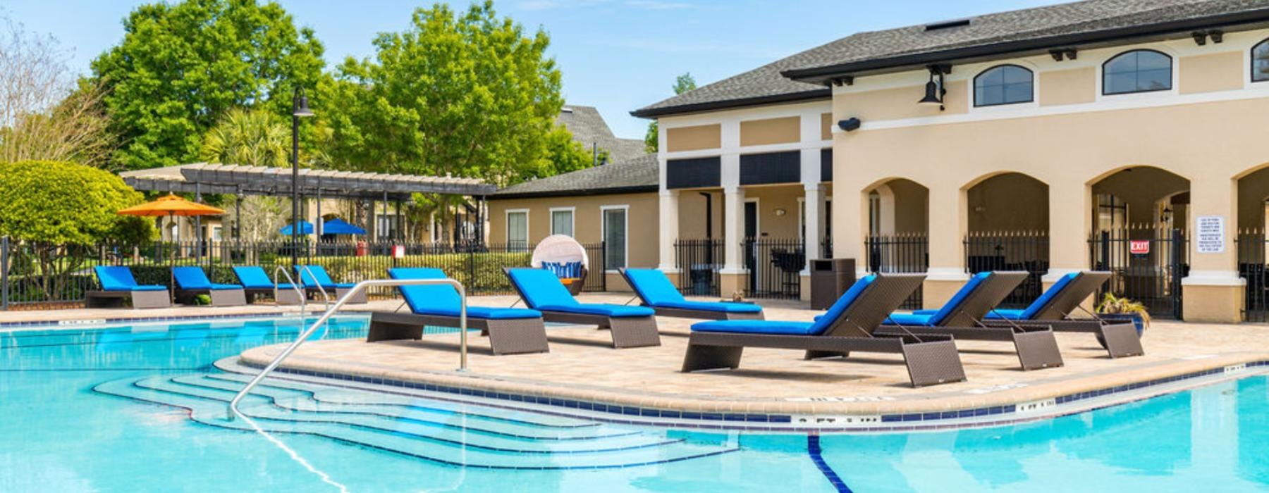 a swimming pool with lounge chairs