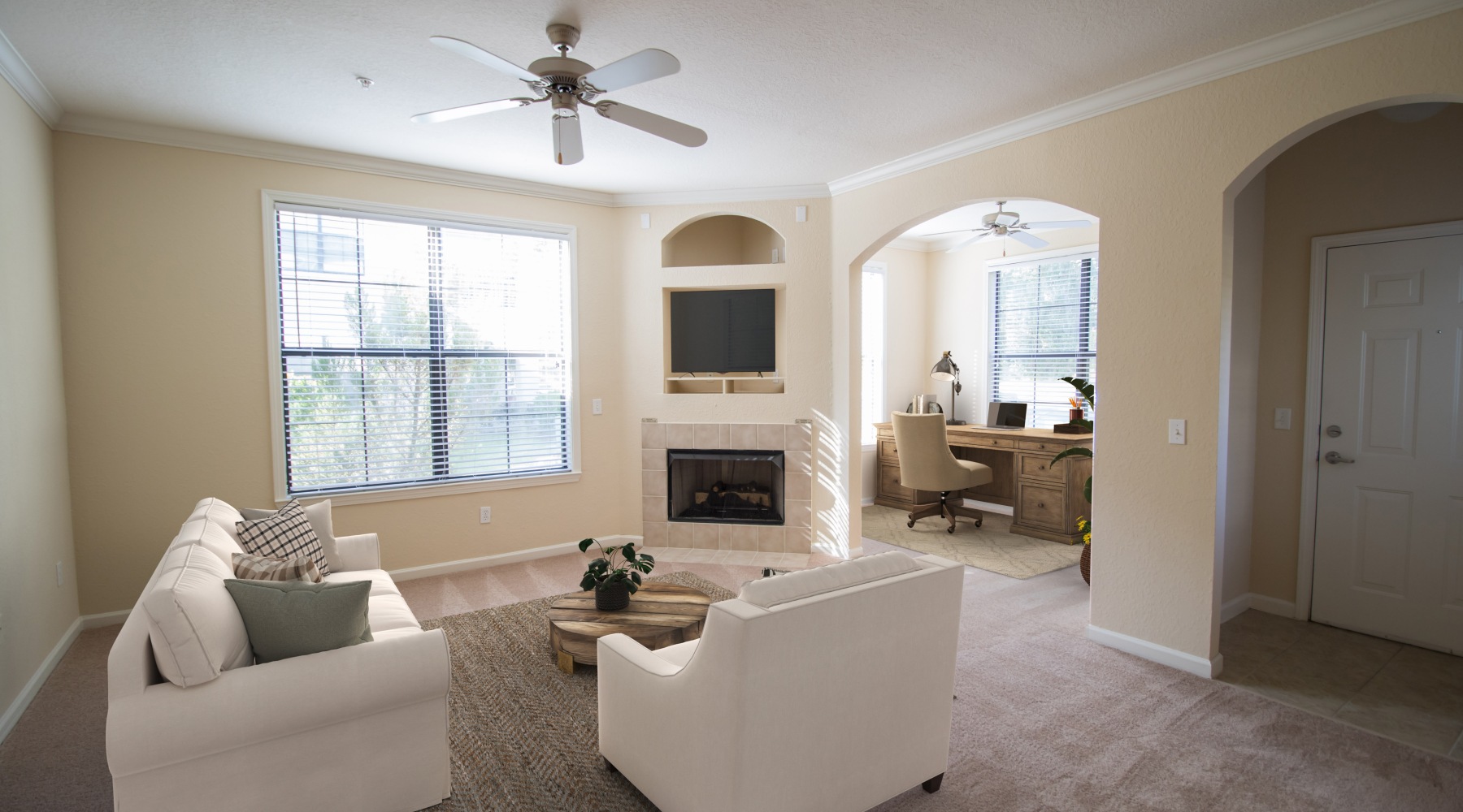 The Art of Living living room with a large window and open spaces